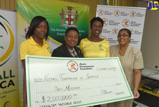 Minister of Culture, Gender, Entertainment and Sport, Hon. Olivia Grange (second left), hands over a cheque for $2 million for the staging of the 2018 'Sunshine Series'. From left are member of Jamaica's Sunshine Girls, Shanice Beckford; President of Netball Jamaica, Dr. Paula Daley-Morris; and Financial Controller at Sports Development Foundation (SDF), Charmaine Hanson. Occasion was the launch of the international netball test series on October 3 at the Ministry’s Trafalgar Road offices in Kingston.  The Sunshine Series, involving Jamaica’s Sunshine Girls, the Calypso Girls of Trinidad and Tobago and reigning Commonwealth Champions, the England Roses, will take place at the National Indoor Sports Centre on October 7, 9, 11, 13 and 15.