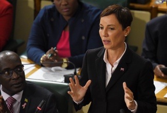 Minister of Foreign Affairs and Foreign Trade, Senator the Hon. Kamina Johnson Smith, addresses today's (October 19) sitting of the Senate. At left is Minister of Education, Youth and Information, Senator the Hon. Ruel Reid.