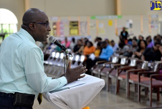 Minister of Education, Youth and Information, Senator the Hon. Ruel Reid (left), speaking to teachers and principals at a Teacher Sensitisation and Consultation Session, held on Tuesday (October 2) at the Old Harbour New Testament Church in St. Catherine.