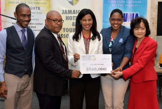 Kingston City Run Founder and Organising Committee Co-Chair, Nicola Madden-Greig (centre), presents a cheque in the sum of $610,000 to Food for the Poor’s Development and Marketing Manager, Marsha Burrell Rose (second right). Occasion was the presentation of cheques to five charities by the Kingston Chapter of the Jamaica Hotel and Tourist Association (JHTA), during a brief ceremony at The Jamaica Pegasus hotel in New Kingston on Thursday (October 11). Others sharing the moment (from left) are Kingston City Run Co-Chair and Chapter Chairman, Christopher Jarrett; Deputy Mayor of Kingston, Councillor Winston Ennis; and JHTA Executive Director, Camille Needham.