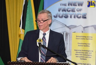 Counsellor and Head of Development Cooperation at the Canadian High Commission, Walter Bernyck, addresss a recent press conference at the Ministry of Justice's Constant Spring  Road offices, St. Andrew.