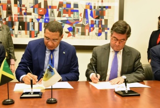 Prime Minister, the Most Hon. Andrew Holness (left), along with President of the Inter-American Development Bank (IDB), Luis Alberto Moreno, sign a US$285-million contingency credit facility on November 26 in Washington DC.