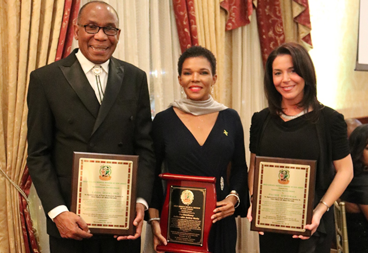 Jamaica’s Ambassador to the United States, Her Excellency Audrey Marks (centre), proudly displays her 2018 HELP Jamaica Medical Mission Distinguished Presidential Award. She is flanked by Humanitarian awardee Dr. Leon Dick (left); and Community Service awardee, CEO of East Orange General Hospital, Paige Dworak. Occasion was HELP Jamaica Medical Mission's fundraising black-tie gala held recently at Hanover Manor, East Hanover, New Jersey.