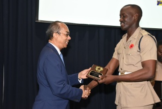 Minister of National Security, Hon. Dr. Horace Chang (left) presents a special award to Private Addo Abendigo for displaying outstanding leadership and academics, proper dress and deportment, and the core values of the Jamaica Defence Force (JDF). Occasion was the end of programme ceremony for the Jamaica National Service Corps Intake 1702, held at Up Park Camp on November 2.