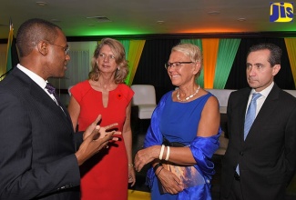 Finance and the Public Service Minister, Dr. the Hon. Nigel Clarke (left), converses with (from second left), Canada’s High Commissioner to Jamaica, Her Excellency Laurie Peters; Head of the European Union Delegation to Jamaica, The Bahamas, and Turks and Caicos Islands, Ambassador Malgorzata Wasilewska; and World Bank Vice President, Jorgé Familiar, during Wednesday’s (November 7) public forum at The Jamaica Pegasus hotel in New Kingston, under the theme ‘Facing the Fiscal Risk of Natural Disasters’. The forum was jointly hosted by the Finance and the Public Service Ministry and the World Bank.