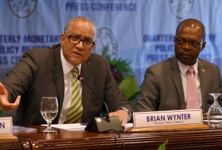 Governor of the Bank of Jamaica (BOJ), Brian Wynter, addresses the quarterly monetary policy report press conference, held at the Bank’s downtown Kingston offices on November 19. At right is Deputy Governor, BOJ, Livingstone Morrison.

