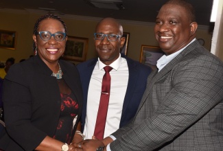 Principal Director of the Climate Change Division in the Economic Growth and Job Creation Ministry, Una May Gordon (left) shares in a photo opportunity with Senior Development Officer, at the Canadian High Commission, Walric Peddie (centre) and Executive Director of the Scientific Research Council, Dr. Cliff Riley. Occasion was the inaugural staging of the Caribbean Climate Innovation Summit and Demo Day at the Knutsford Court Hotel in New Kingston on November 2.