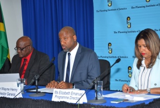 Planning Institute of Jamaica (PIOJ) Director General, Dr. Wayne Henry (centre), addressing journalists during the quarterly media briefing at the PIOJ’s New Kingston head office on Wednesday (November 21). Others (from left) are Senior Director for the PIOJ’s Economic Planning, Research and Policy Logistics Division, James Stewart; and Programme Director for the Vision 2030 Jamaica Secretariat, Elizabeth Emanuel.