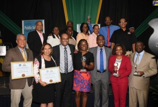 Minister of Finance and the Public Service, Dr. the Hon. Nigel Clarke (third right, front row); and President of the Private Sector Organisation of Jamaica (PSOJ), Howard Mitchell (third left, front row), with the winners at the PSOJ 2018 Public Bodies Corporate Governance Awards  held at The Jamaica Pegasus hotel in Kingston on December 12.