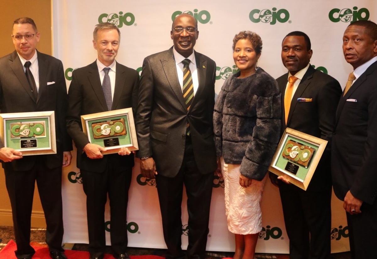 Minister of Education, Youth and Information, Senator the Hon. Ruel Reid (third left) and Jamaica’s Consul General to New York, Trudy Deans (fourth left), with (from left),  Children of Jamaica Outreach (COJO) 2018 awardees - Phillip Feurtado, CEO, Feurtado Shipping;  Chairman, Rockhouse Hotel, Paul Salmon; Founder/ Managing Partner of Capital Markets and Finance, Gopal Burgher  and  Founder and Chairman of COJO,  Gary Williams, at  the 24th Annual Fundraising Scholarship Gala and awards ceremony, held on December 1 at the Hilton JFK Hotel in New York.