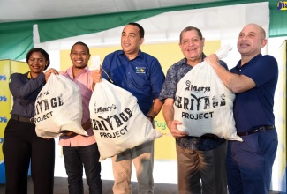 State Minister in the Ministry of Education, Youth and Information, Hon. Floyd Green (second left); Minister of Health, Dr. the Hon. Christopher Tufton (third left), and Minister of Industry, Commerce, Agriculture and Fisheries, Hon. Audley Shaw (fourth left), holding bags with bananas they received during the launch of the Jamaica Producers Group’s St. Mary Heritage Project, on Friday (December 14) at the company’s farm in Annotto Bay, St. Mary. Presenting the bags are Commercial Manager, JP Tropical Foods Limited, Tara Goulbourne (left) and Chief Executive Officer, Jamaica Producers Group, Jeffrey Hall.
 
