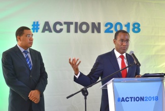 Prime Minister, the Most Hon. Andrew Holness (left), listens as Finance and the Public Service Minister, Dr. the Hon. Nigel Clarke, addresses journalists on matters related to State refinery, PETROJAM, during a press conference on Monday (December 10). The press conference was held at the Office of the Prime Minister (OPM).