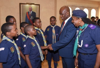 Deputy Governor-General, Hon. Steadman Fuller (second right), interacts with members of the Scout Association of Jamaica, while Assistant Chief Commissioner of the Association in charge of Cubs, Karen Harriott Wilson (right), looks on. Occasion was the recent launch of Caribbean Cuboree 2019, at King’s House.