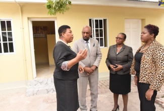 Minister of State in the Ministry of National Security, Hon. Rudyard Spencer (second left), listens to Deputy Commissioner, Custodial Services, Department of Correctional Services (DCS), Joyce Stone (left), at the official reopening of the Howard Pre-release Hostel located at the Tower Street Adult Correctional Centre in Kingston, on January 8. Commissioner of Corrections, Ina Hunter (second right); and Acting Chief Technical Director, Research, Rehabilitation and Diversion Policy Division, Ministry of National Security, Shauna Trowers, also share in the conversation.