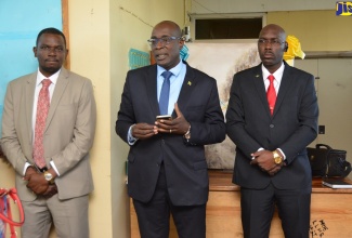 Minister of Education, Youth and Information, Senator the Hon. Ruel Reid (centre), with Principal of the Little London High School in Westmoreland, Garfield James (left); and Director of the Safety and Security Programme in the Ministry, Assistant Superintendent of Police, Coleridge Minto (right), during a visit to the school on January 8. 