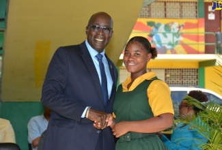 : Minister of Education, Youth and Information, Senator the Hon. Ruel Reid (left), congratulates grade-10 student of Grange Hill High School, Amoy James (right), on her success in the 2018 sitting of the Caribbean Secondary Education Certificate (CSEC) examination, during a visit to the institution on January 8. 