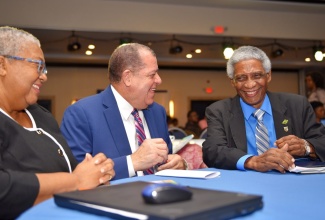 Minister of Industry, Commerce, Agriculture and Fisheries, Hon. Audley Shaw (centre), engages with Pro-Chancellor, The Mico University College, Professor Neville Ying (right), and Managing Director, Jamaica Stock Exchange (JSE), Marlene Street Forrest, at the Jamaica Stock Exchange (JSE) Investments and Capital Markets Conference at the Jamaica Pegasus hotel in New Kingston on Thursday (January 24).