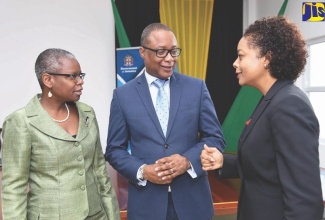 Attorney General, Hon. Marlene Malahoo Forte (right), converses with Solicitor General, Nicole Foster-Pusey (left), and Deputy Financial Secretary, Ministry of Finance and the Public Service, Dunstan Bryan, at the launch of a technical training programme for attorneys in central government at the Ministry of Justice.