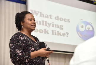 Legal and Policy Specialist at the Child Protection and Family Services Agency (CPFSA),  Tania Chambers, makes a presentation on the Child Care and Protection Act, at a two-day technical workshop on bullying, held at the Police Officers' Club in St. Andrew from February 20 to 21.