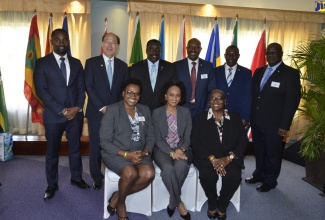 Minister of Transport and Mining, Hon. Robert Montague (third from left, standing), with Secretary General of the International Maritime Organization, Kitack Lim (second left, standing) and Caribbean Transportation Ministers at a  High Level Symposium held at the Iberostar Hotel in Rose Hall,  St. James, on Wednesday, February 27. 