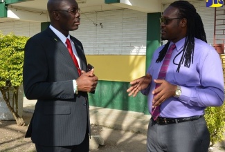 Dean of Discipline at Petersfield High in Westmoreland, Junior Clarke (right), in discussion with former Director of  the Safety and Security in Schools Programme, Assistant Superintendent of Police (ASP) Coleridge Minto, during a recent visit to the institution. 