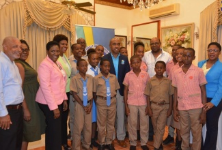 Tourism Minister, Hon Edmund Bartlett (fifth right), Executive Director of the Tourism Product Development Company Limited (TPDCO), Dr. Andrew Spencer (centre); and Permanent Secretary in the Tourism Ministry, Jennifer Griffith (fourth left) with the principals, coaches and students of Mount Airy All-Age and Broughton Primary Schools, who were finalists in the TVJ 2018 Junior Schools’ Challenge Quiz competition. 