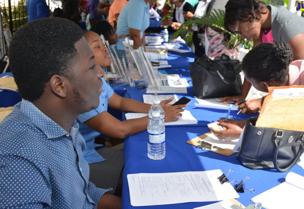 Members of the public (right) complete application forms at the HEART   Trust/NTA  booth, while representatives of the agency look on. Occasion was  a recent career and information forum and exposition staged by the HEART Trust/NTA at Sam Sharpe Square  in Montego Bay.
 
