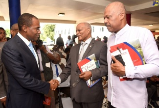 Minister of Finance and the Public Service, Dr.the Hon. Nigel Clarke (left), greets former Governor-General, the Most Hon. Sir Kenneth Hall (centre), during the opening ceremony for the University of the West Indies' (UWI) Research Days at the Mona campus on February 6. Looking on is UWI Vice Chancellor, Professor Sir Hilary Beckles. The UWI Research Days, which is in its 20th year, runs from February 6 to 8.