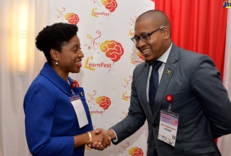 Minister of State in the Ministry of  Education, Youth and Information, Hon. Floyd Green (right), greets Founder of LearnFest Caribbean and Chief Executive Officer of Project Management Global Institute (PGMI), Sherrone Blake Lobban, during the recent LearnFest Caribbean 2019 symposium at The Jamaica Pegasus hotel in Kingston. Mr. Green was the keynote speaker.