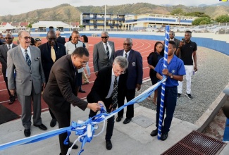 Prime Minister, the Most Hon. Andrew Holness (left), and Michael Ashenheim (second left), cut the ribbon to officially open the Ashenheim Stadium on the grounds of Jamaica College at its Old Hope Road location in St. Andrew on Wednesday (February 20). The Ashenheim family donated the state of-the-art facility. Also pictured in the background (from left) are Chairman, Project Committee, Dr. the Hon. R. Danny Williams; Minister of Education, Youth and Information, Senator the Hon. Ruel Reid; Minister of Science, Energy and Technology, Hon. Fayval Williams; Chairman of JC Board of Management, Michael Bernard; and the school’s Principal, Wayne Robinson.