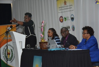 Permanent Secretary in the Ministry of Education, Youth and Information, Dr. Grace McLean, addresses the National College for Education Leadership (NCEL)/National Council on Education (NCE) training session for principals and Board chairpersons held recently at the Melia Braco Village in Trelawny. Seated  (l-r) are Director and Principal of NCEL, Dr. Taneisha Ingleton; Chairman of the Teachers’ Services Commission and Custos of St. James, Conrad Pitkin; and Executive Director of the NCE, Merris Murray.