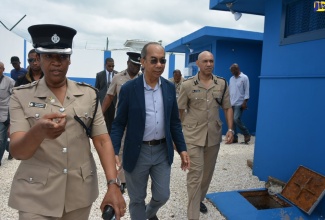 Minister of National Security , Hon. Dr. Horace Chang (centre); and Commissioner of Police, Major General Antony Anderson (right) , are led on a tour of the Jamaica Constabulary Force (JCF) Hanover Divisional Headquarters in Lucea by Commanding Officer for the parish, Superintendent Sharon Beeput. The Minister stopped at the Hanover police headquaters on Thursday (March 28), during a tour of police facilities in western Jamaica. 
 
