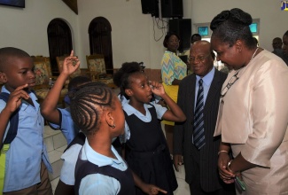 Acting Permanent Secretary in the Ministry of Education, Youth and Information, Dr. Grace McLean (right) engages students from the Eltham Park Primary School in a conversation, at the National Mathematics Week Church Service held on March 24 at the Life Centre Church of God of Prophecy, Gordon Boulevard, Spanish Town, St. Catherine. Looking on is Bishop Johnathan Hayden, Pastor Life Centre Church of God of Prophecy.