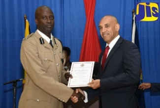 Commissioner of Police, Major General Antony Anderson (right), presents Assistant Commissioner of Police,  McArthur Sutherland with a certificate during the National Police College of Jamaica (NPCJ) Strategic Command Course 2019 graduation ceremony, at Twickenham Park, St. Catherine, on March 29.