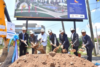 Prime Minister, the Most Hon. Andrew Holness (centre), participates in the breaking of  ground for Guardian Life Limited's 176-unit luxury apartment complex in New Kingston on  Thursday (March 21).  Others (from left) are Architect for the project, Michael Lake; Opposition Spokesperson for Housing, Morais Guy; Member of Parliament for South East St. Andrew, Julian Robinson; President of Guardian Life Limited, Eric Hosin; Chief Operating Officer, National Commercial Bank, Septimus Blake; and Minister of National Security, Hon. Dr. Horace Chang. The $4-billion real estate project is being undertaken by Guardian Life Limited at its Musgrave Avenue property.
 
