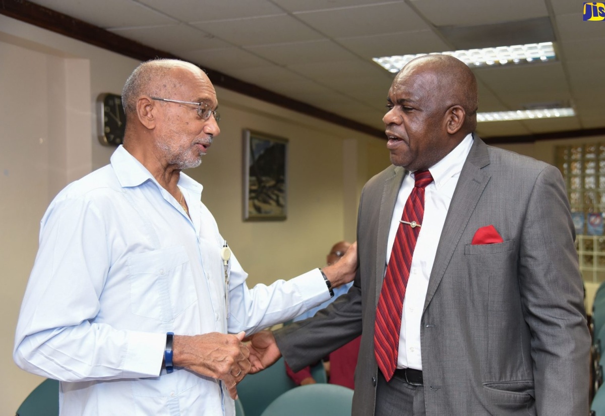 Director of the Centre for Disability Studies at the University of the West Indies (UWI), Mona Campus, Senator Dr. Floyd Morris (right), greets Patron of the National Child Month Committee (NCMC), Hon. Douglas Orane, at the launch of Child Month 2019, which was held recently at the GraceKennedy office in downtown Kingston.