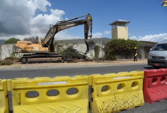 Work in progress along a section of South Camp Road in St. Andrew, to relocate the Jamaica Defence Force's main entranceT. The project is being funded under the Major Infrastructure Development Programme (MIDP) and is slated to run for six-months. 
 
