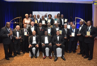 Governor-General, His Excellency, the Most Hon. Sir Patrick Allen (seated left); Custos  St. James, Bishop, the Hon. Conrad Pitkin (seated centre) and Mayor of Montego Bay and Chairman of the St. James Municipal Corporation, Councillor Homer Davis (seated right),  with Justices of the Peace awarded for  excellence in service at  the Inaugural Custos Awards banquet, held at the Hilton Rose Hall Resort and Spa, in St. James, on Saturday (April 27). 