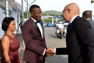 Governor-General, His Excellency the Most Hon. Sir Patrick Allen (right), is greeted by Managing Director, FosRich Company Limited, Cecil Foster (centre), at the company’s  25th anniversary dinner and awards ceremony, held on Sunday (May 19) at the Spanish Court Hotel in New Kingston. At left is Board Chair, FosRich Company Limited, Marion Foster.  FosRich Company Limited is a major importer and distributor of electrical and lighting products. 