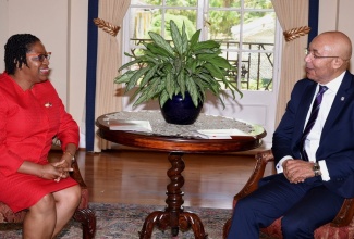 Governor-General, His Excellency the Most Hon. Sir Patrick Allen (right), in conversation with President of  the Jamaica Red Cross, Hope Munroe, as executive members of organisation visit King’s House on Tuesday (May 14).