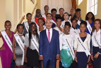 Governor-General, His Excellency the Most Hon. Sir Patrick Allen (centre), with contestants in the Miss Global Jamaica Beauty Pageant, who visited King’s House on May 17.