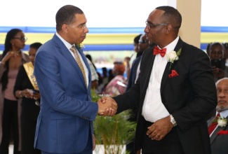 The Most Hon Andrew Holness, Prime Minister greeting the President of the Jamaica Civil Service Association, O'Neil Grant.