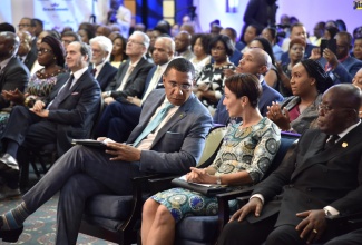 Prime Minister, the Most Hon. Andrew Holness (third right), engages  with Minister of Foreign Affairs and Foreign Trade, Senator the Hon. Kamina Johnson Smith (centre), at  the opening ceremony for the Eighth Biennial Jamaica Diaspora Conference at The Jamaica Pegasus Hotel in New Kingston on Sunday (June 16).  At right is President of the Republic of Ghana, His Excellency Nana Addo Dankwa Akufo-Addo. 