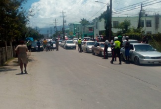 The Westmoreland Police conduct an operation on Great George Street in Savanna-la-Mar, Westmoreland.