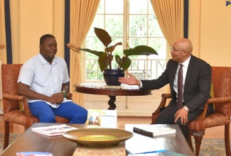 Governor-General, His Excellency the Most Hon. Sir Patrick Allen (right), in  conversation with Chief Executive Officer of the Life Pak Foundation Limited, Dr. Farin Williams, during his call at King’s House on June 11.