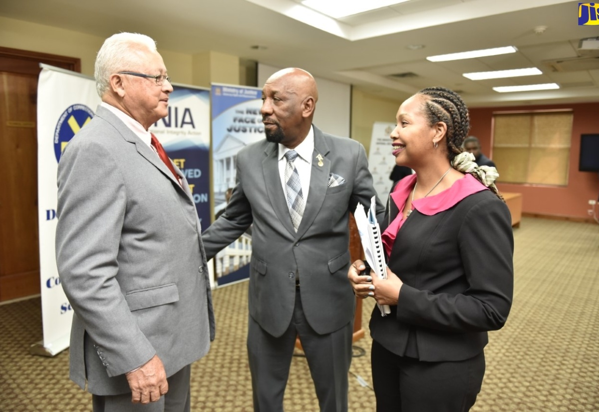 State Minister for National Security, Hon. Rudyard Spencer (centre), engages with  Minister of Justice, Hon. Delroy Chuck; and Child Diversion Consultant, Ruth Carey. Occasion was the Justice Ministry’s ‘Child Diversion Programme stakeholders’ sensitisation session held at the University of the West Indies Regional Headquarters in St. Andrew on Wednesday (July 10).