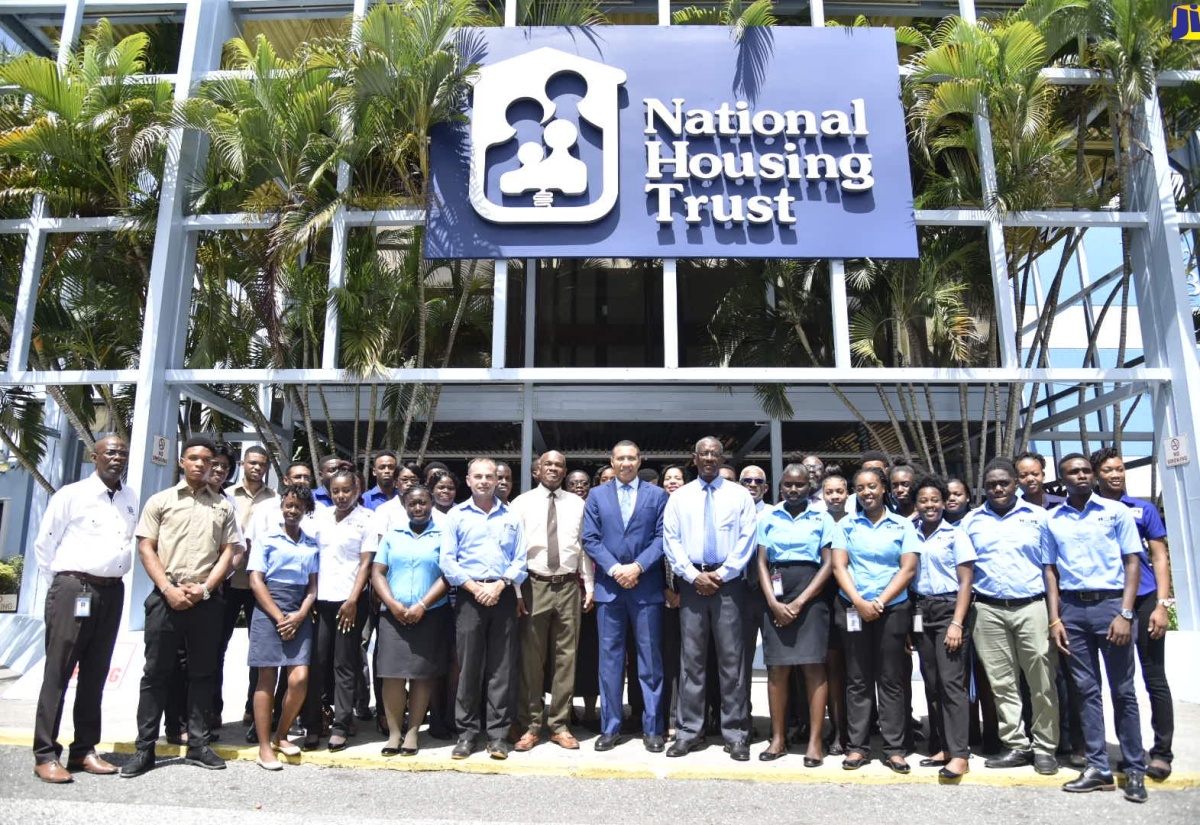 Prime Minister, the Most Hon. Andrew Holness (centre), poses with the Housing, Opportunity, Production and Employment (HOPE) Programme interns and facilitators, along with executives of the National Housing Trust (NHT), during a visit to the NHT head office in New Kingston. The visit was one of several by Mr. Holness to HOPE projects across the Corporate Area on Wednesday (July 24). Also pictured (at sixth left) is National Coordinator of the HOPE Programme, Lt. Col. Martin Rickman.
