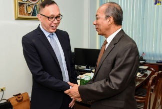 National Security Minister, Hon. Dr. Horace Chang (right), greets outgoing Chargé d’Affaires at the United States Embassy in Jamaica, Eric Khant, who visited the Ministry’s New Kingston offices on Wednesday (July 10), to say farewell.