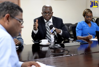 Minister without Portfolio in the Ministry of Economic Growth and Job Creation, Senator the Hon. Pearnel Charles Jr. (second right), highlights a point during a meeting at the Minister’s New Kingston offices on Tuesday (July 16) to discuss solutions to the water shortage aftecting the West Rural and East Rural St. Andrew constituencies. At right is Member of Parliament for West Rural St. Andrew, Juliet Cuthbert-Flynn.