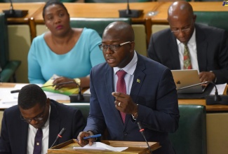 (FILE) Minister without Portfolio in the Ministry of Economic Growth and Job Creation, Senator the Hon. Pearnel Charles Jr., opening the debate on the Petroleum (Amendment) Act, 2019 in the Senate on June 28. Seated (at left) is Parliamentary Secretary, Senator Robert Morgan. In the background (from left) are Senator Kerensia Morrison, and Deputy President of the Senate, Aubyn Hill. 